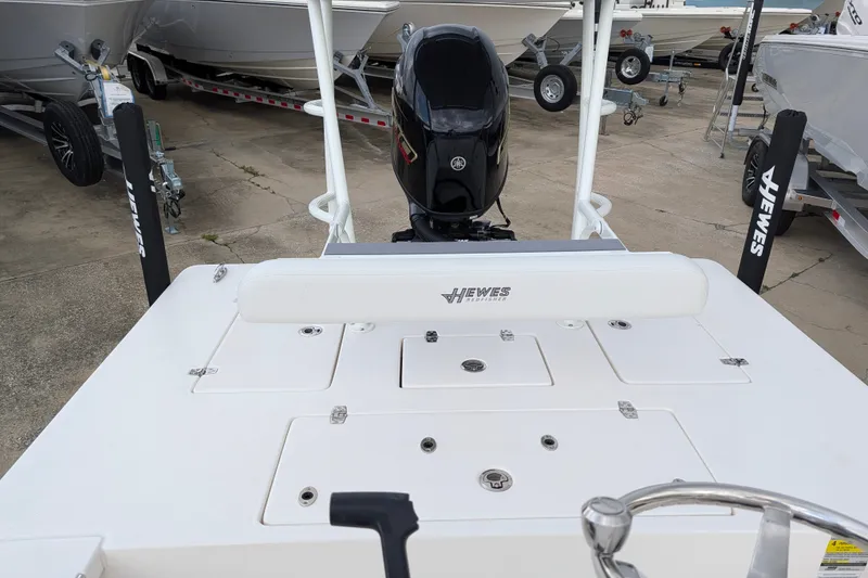 Slide: The Image of 2027 Hewes Redfisher 18 boat with Yamaha outboard motor, displayed on a trailer. - 21