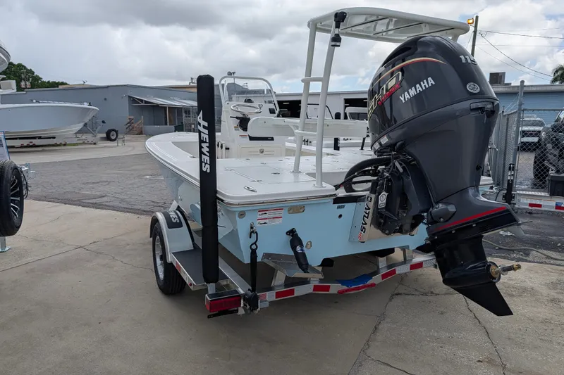Slide: The Image of 2027 Hewes Redfisher 18 boat with Yamaha engine on trailer, parked outdoors. - 5