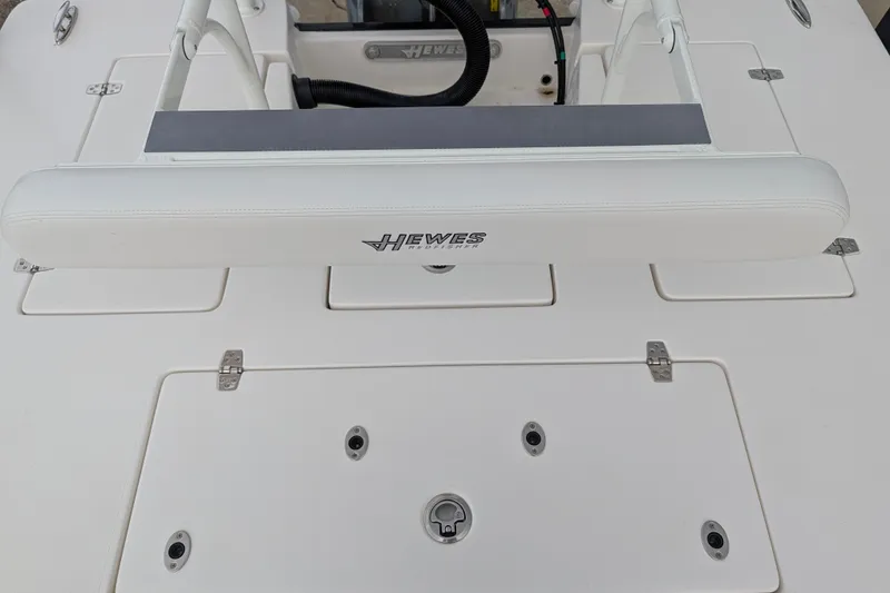 Slide: The Image of 2027 Hewes Redfisher 18 boat deck with storage compartments and seating. - 10