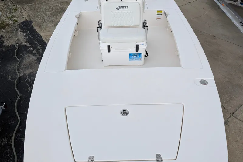 Slide: The Image of 2027 Hewes Redfisher 18 boat deck with cooler and seating. - 18