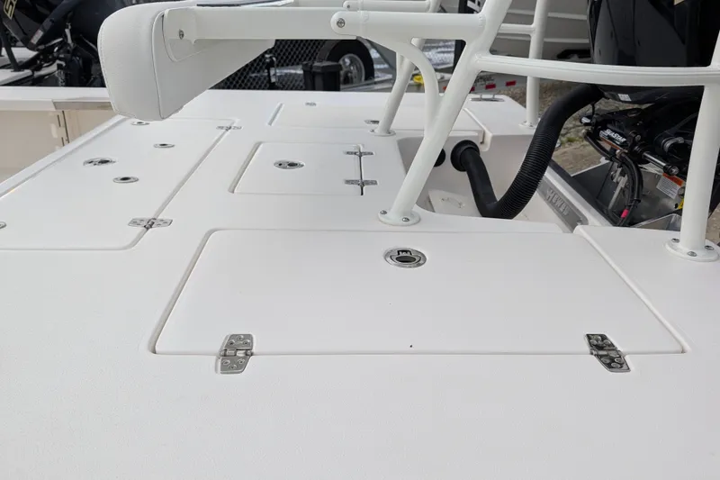 Slide: The Image of 2027 Hewes Redfisher 18 boat deck with storage compartments and Yamaha engine. - 30
