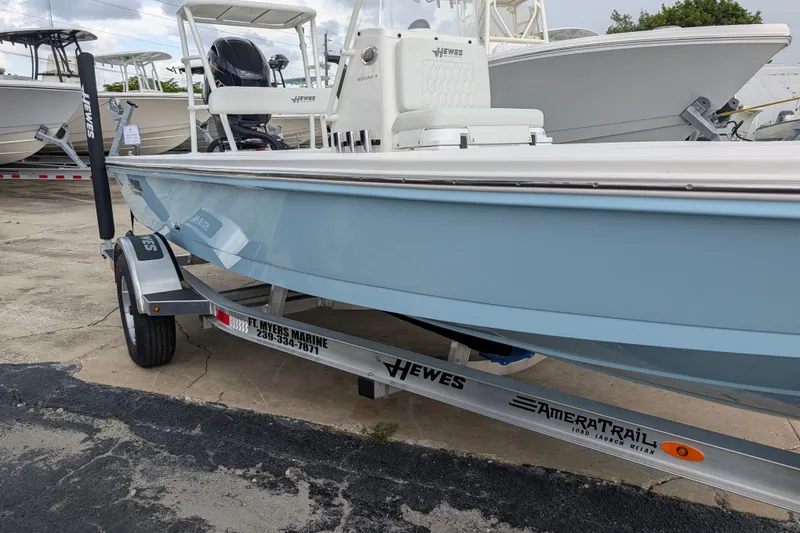 Slide: The Image of 2027 Hewes Redfisher 18 boat on trailer, light blue hull, parked at marina. - 4
