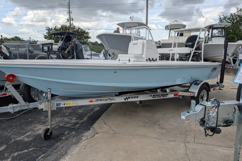 The Image of 2027 Hewes Redfisher 18 boat on trailer, displayed outdoors under cloudy sky. - 0