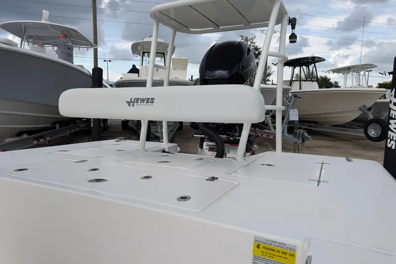 Slide: The Image of 2027 Hewes Redfisher 18 boat displayed at a marina, showcasing sleek design and modern features. - 31