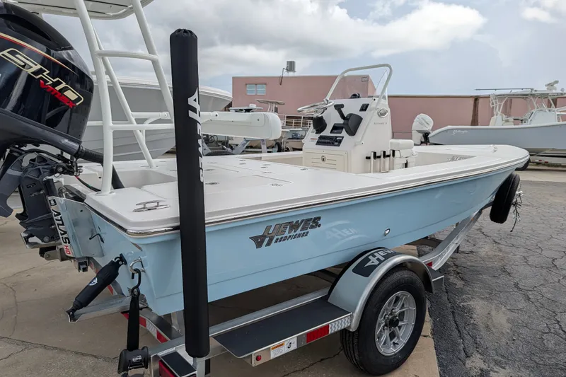 Slide: The Image of 2027 Hewes Redfisher 18 boat on trailer, featuring Yamaha engine, parked outdoors. - 7