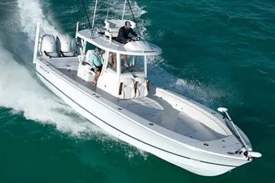 The Image of 2027 Regulator 30XO boat cruising on open water with two passengers. - 1