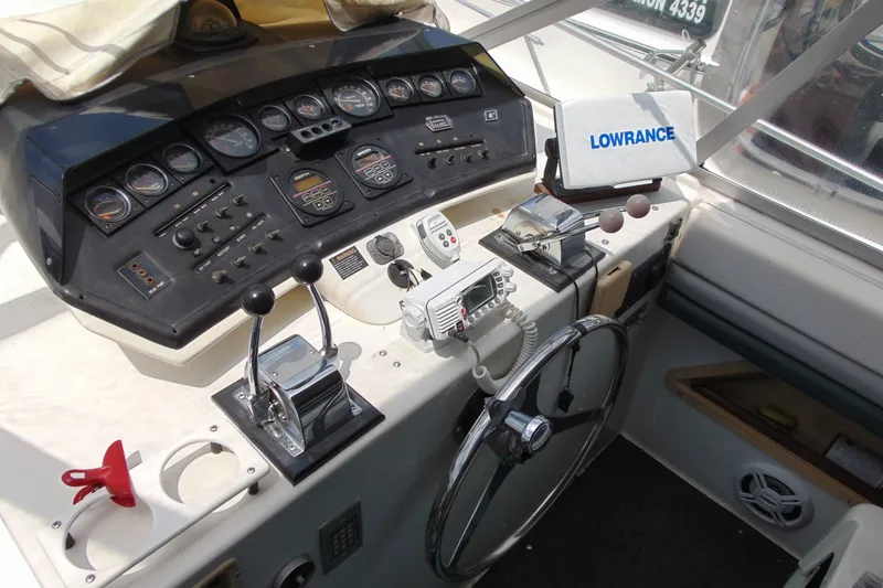 Slide: The Image of 1988 Trojan International 10M boat dashboard with navigation equipment and steering wheel. - 14