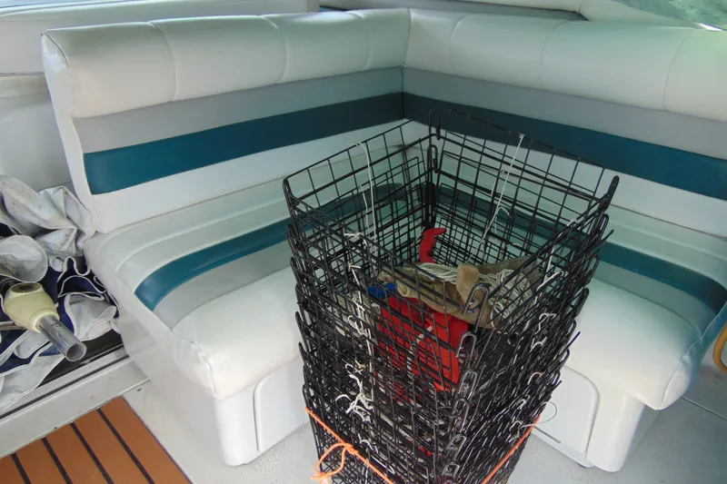 Slide: The Image of Interior of 1988 Trojan International 10M boat with seating and fishing gear. - 15