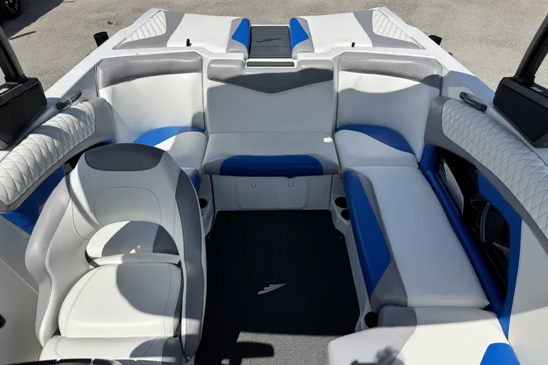 Slide: The Image of 2014 Tigé Z1 boat interior with white and blue seating arrangement. - 16