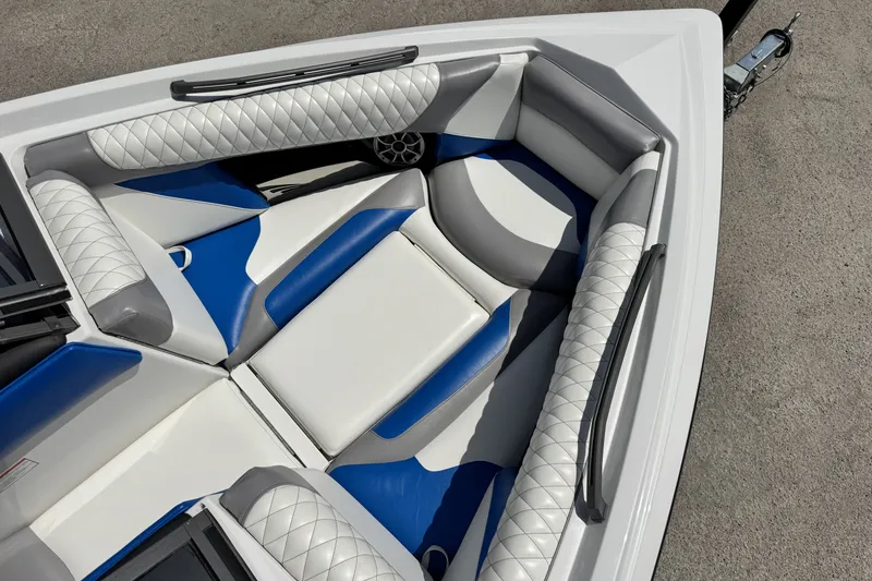 Slide: The Image of 2014 Tigé Z1 boat interior with blue and white cushioned seating. - 15