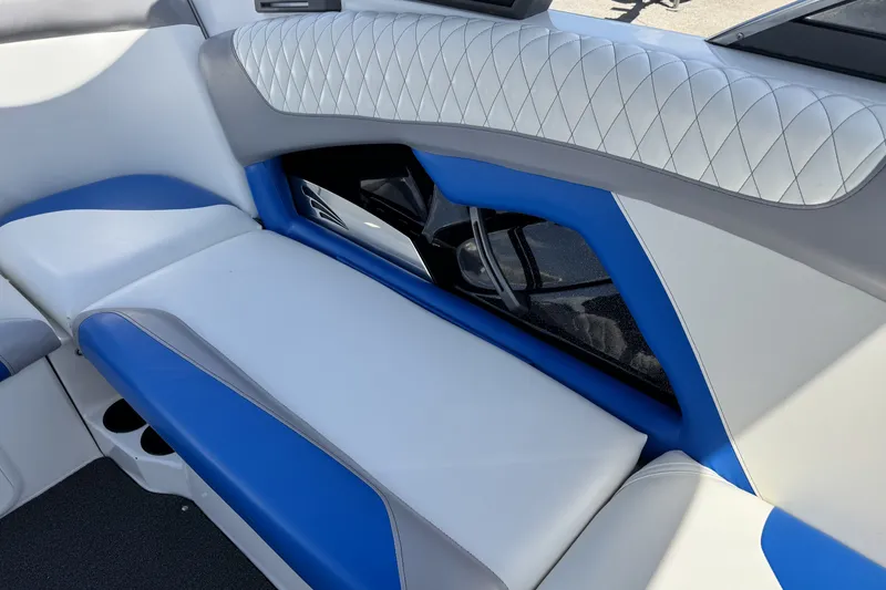 Slide: The Image of 2014 Tigé Z1 boat interior with blue and white cushioned seating. - 17
