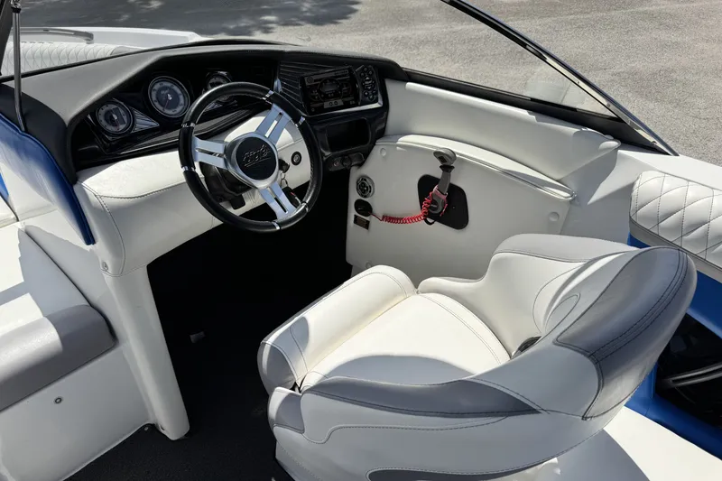 Slide: The Image of 2014 Tigé Z1 boat interior with steering wheel and white seating. - 11