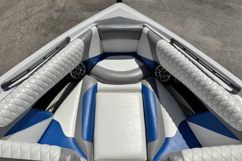 Slide: The Image of 2014 Tigé Z1 boat interior with blue and white cushioned seating. - 14