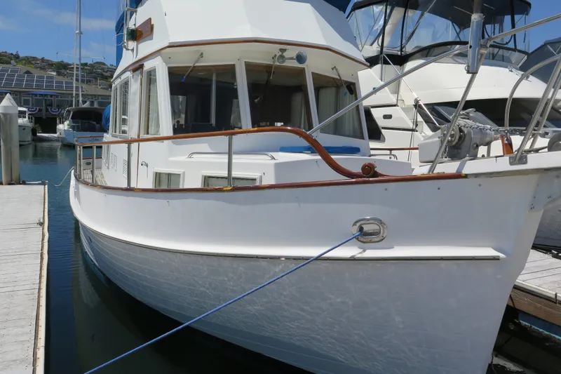 Slide: The Image of 1988 Grand Banks 36 Classic yacht docked at a marina, showcasing elegant design. - 2