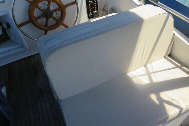 Slide: The Image of Steering wheel and seating area on 1988 Grand Banks 36 Classic boat. - 13