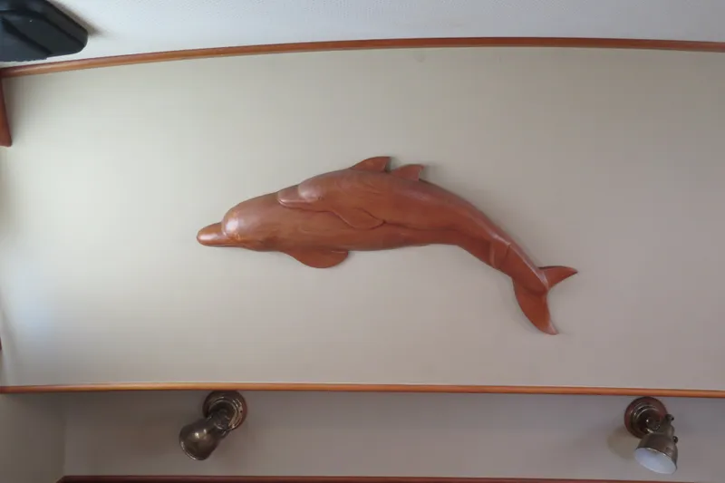 Slide: The Image of Wooden dolphin sculpture on Grand Banks 36 Classic yacht interior wall, 1988 model. - 30