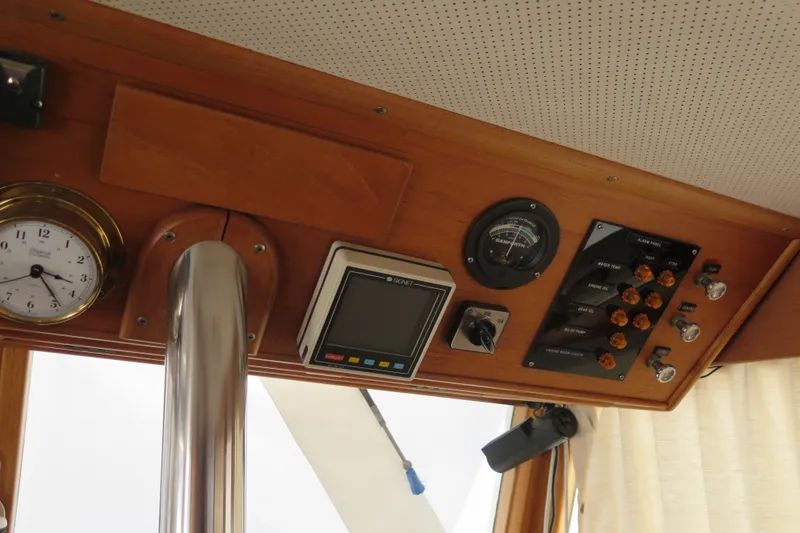 Slide: The Image of Control panel of a 1988 Grand Banks 36 Classic boat with clock and gauges. - 17