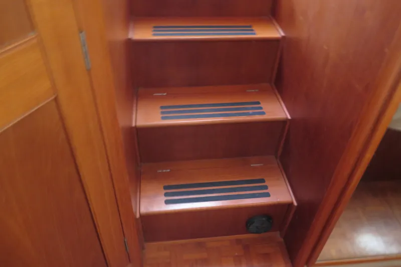 Slide: The Image of Wooden stairs inside 1988 Grand Banks 36 Classic yacht, featuring anti-slip strips. - 26