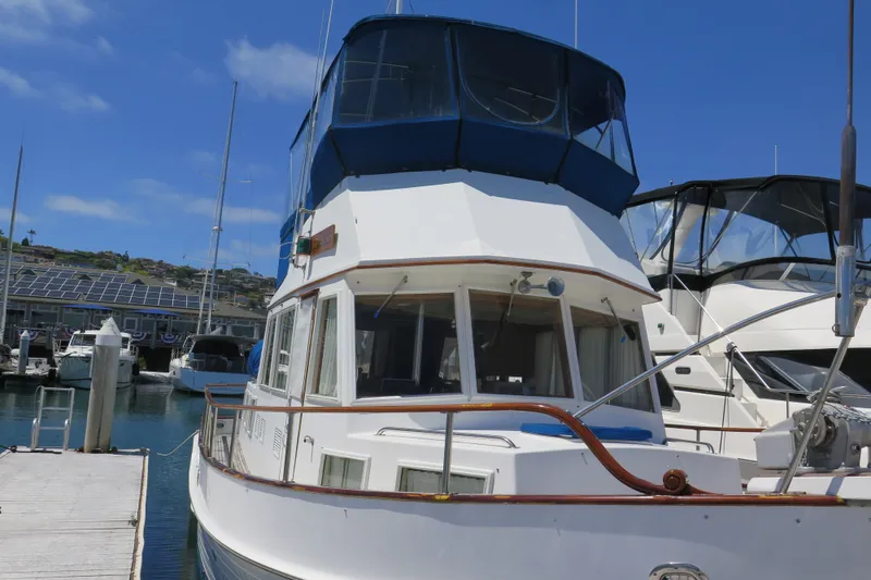 Slide: The Image of 1988 Grand Banks 36 Classic yacht docked at marina under clear blue sky. - 3