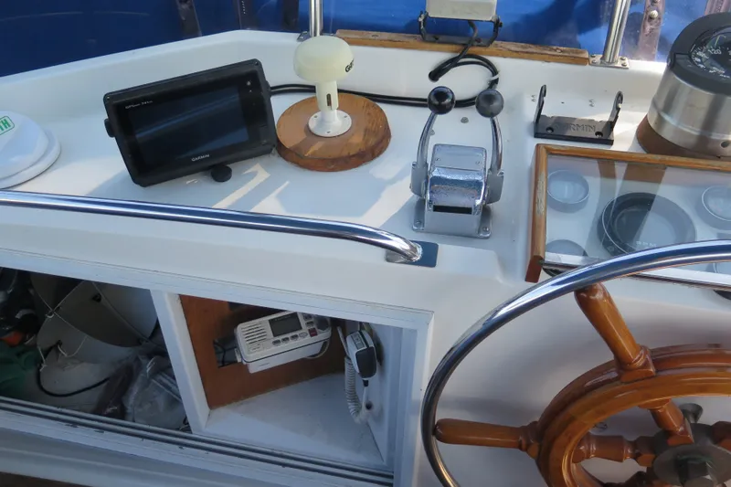 Slide: The Image of Helm of 1988 Grand Banks 36 Classic with navigation equipment and wooden steering wheel. - 12