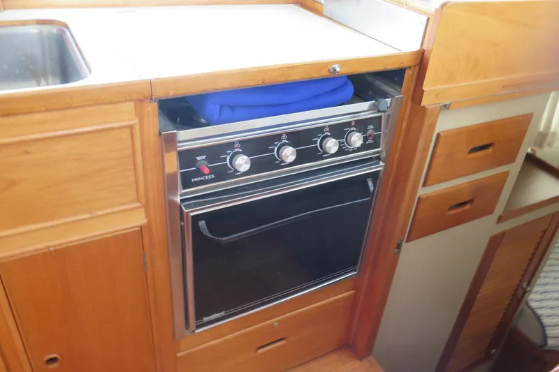 Slide: The Image of Galley kitchen in 1988 Grand Banks 36 Classic yacht with stove and wooden cabinetry. - 24