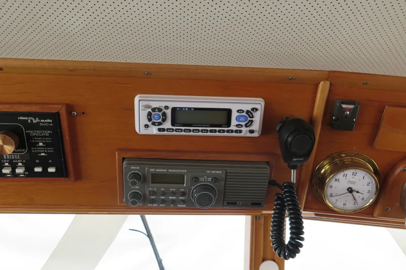 Slide: The Image of Control panel of a 1988 Grand Banks 36 Classic boat with radio and clock. - 16