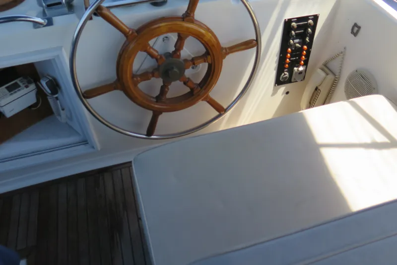 Slide: The Image of Steering wheel and controls of 1988 Grand Banks 36 Classic yacht. - 10