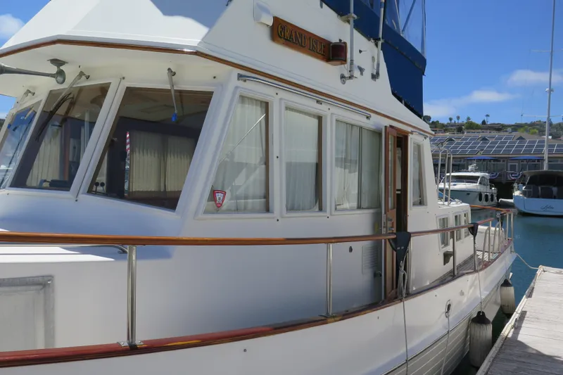 Slide: The Image of 1988 Grand Banks 36 Classic yacht docked at marina, showcasing elegant design and craftsmanship. - 7