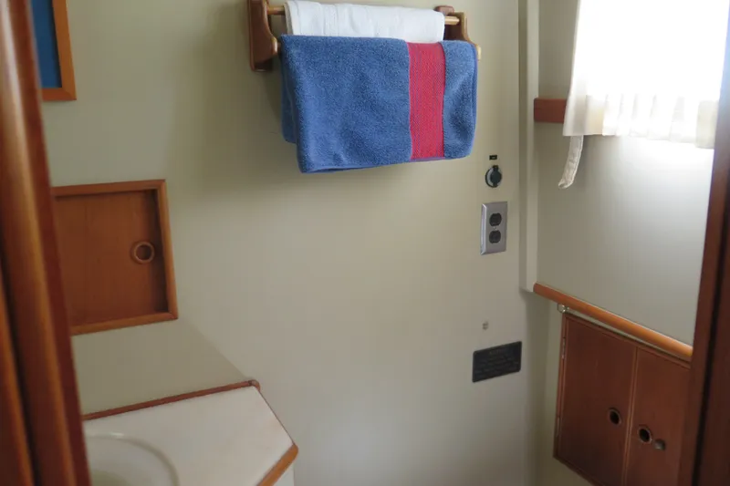 Slide: The Image of Bathroom interior of 1988 Grand Banks 36 Classic yacht with towel rack and wooden cabinetry. - 33