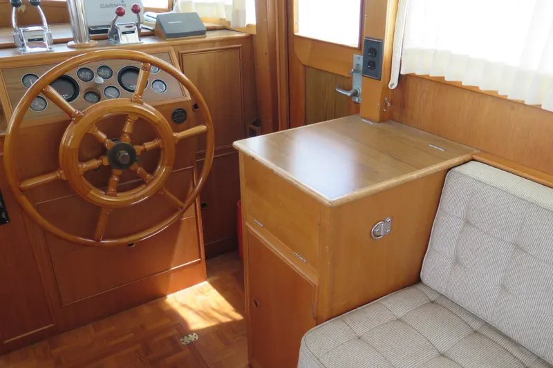 Slide: The Image of Interior helm of 1988 Grand Banks 36 Classic with wooden steering wheel and controls. - 15