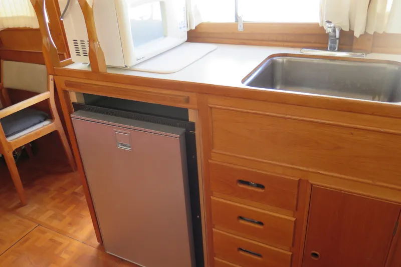 Slide: The Image of Galley kitchen in 1988 Grand Banks 36 Classic yacht with sink, fridge, and microwave. - 25