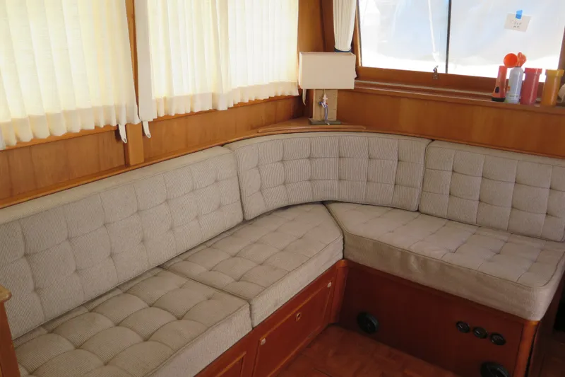 Slide: The Image of Cozy interior of 1988 Grand Banks 36 Classic yacht with cushioned seating and wooden accents. - 22