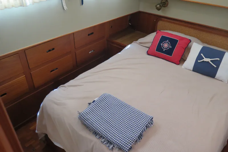 Slide: The Image of Cozy cabin bedroom in 1988 Grand Banks 36 Classic yacht with nautical-themed pillows. - 11