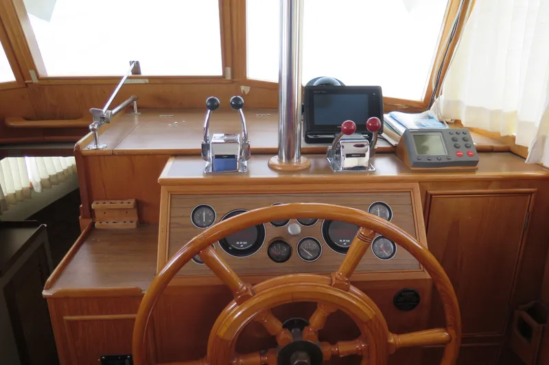 Slide: The Image of Helm of 1988 Grand Banks 36 Classic with wooden wheel and navigation instruments. - 14