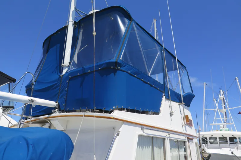 Slide: The Image of 1988 Grand Banks 36 Classic yacht with blue canopy under clear sky. - 6