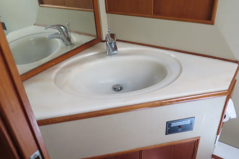 Slide: The Image of Bathroom sink in 1988 Grand Banks 36 Classic yacht, featuring wooden trim and modern faucet. - 32