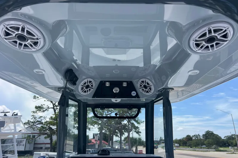 Slide: The Image of 2027 Sportsman Open 282 Center Console boat with overhead speakers and sleek design. - 20