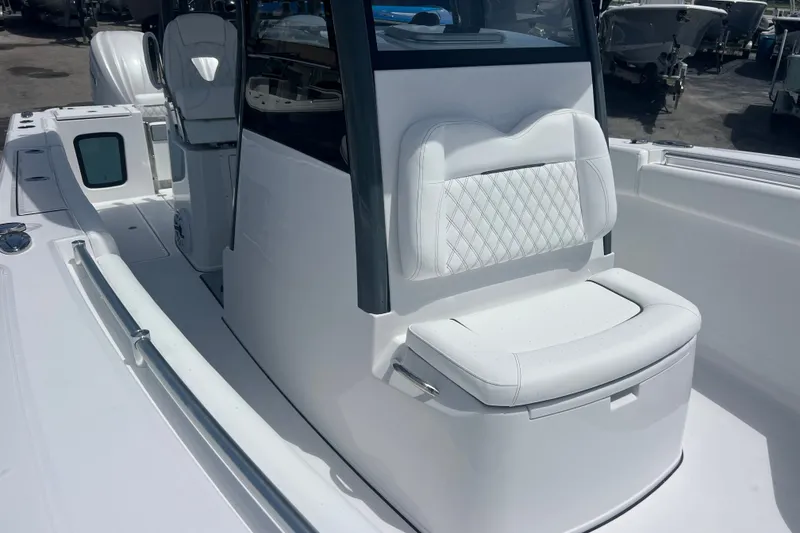 Slide: The Image of 2027 Sportsman Open 282 Center Console boat with white seating and sleek design. - 15