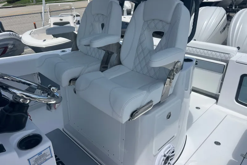 Slide: The Image of 2027 Sportsman Open 282 Center Console with luxurious white seating and modern helm design. - 17