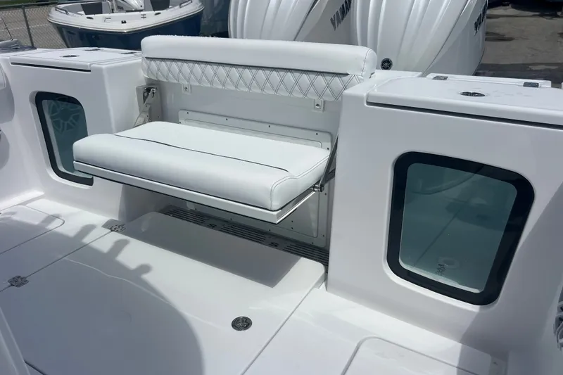 Slide: The Image of 2027 Sportsman Open 282 Center Console boat with white seating and storage compartments. - 19
