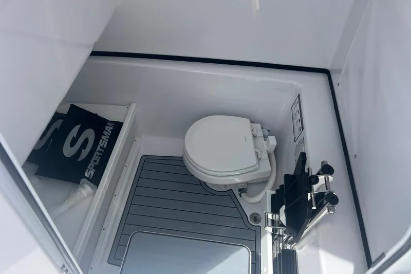 Slide: The Image of 2027 Sportsman Open 282 Center Console boat interior with toilet and storage area. - 16
