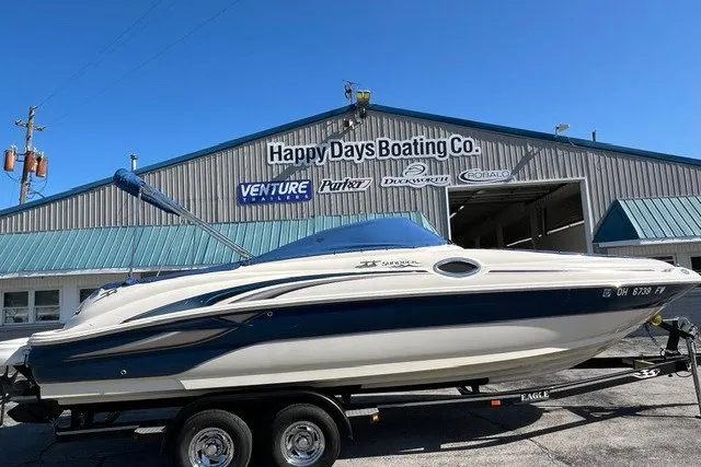 Slide: The Image of 2003 Sea Ray 240 Sundeck boat on trailer at Happy Days Boating Co. dealership. - 2