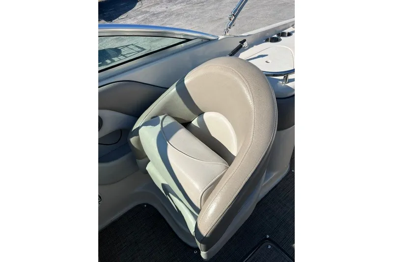 Slide: The Image of 2003 Sea Ray 240 Sundeck boat seat, beige leather, cup holders visible. - 7