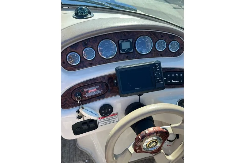 Slide: The Image of Dashboard of a 2003 Sea Ray 240 Sundeck boat with navigation instruments. - 6