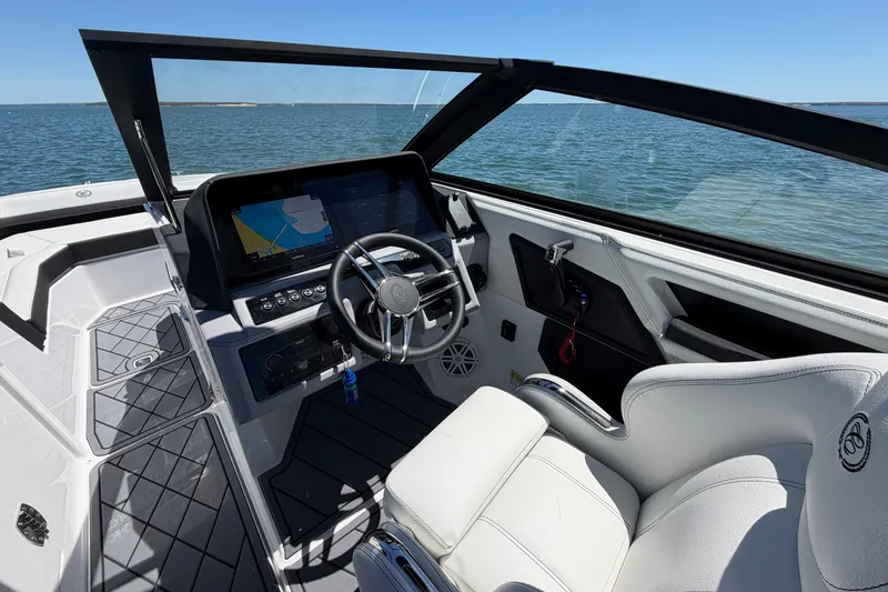 Slide: The Image of 2027 Cobalt R6 Outboard boat interior with modern dashboard and steering wheel on open water. - 13