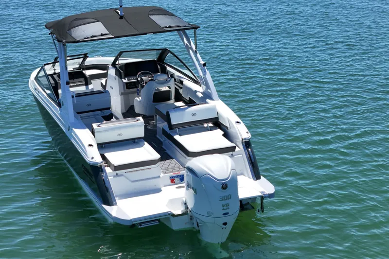 Slide: The Image of 2027 Cobalt R6 Outboard boat on clear blue water, showcasing sleek design and spacious seating. - 2