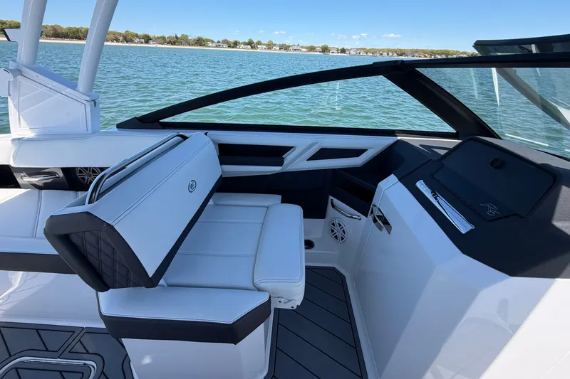 Slide: The Image of 2027 Cobalt R6 Outboard boat interior with sleek seating and modern dashboard on a sunny day. - 16