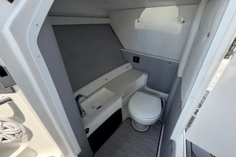 Slide: The Image of 2027 Cobalt R6 Outboard boat interior bathroom with sink and toilet. - 19