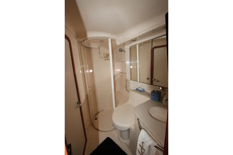Slide: The Image of Bathroom interior of 2001 Sea Ray Sundancer 460 yacht, featuring shower and vanity. - 20