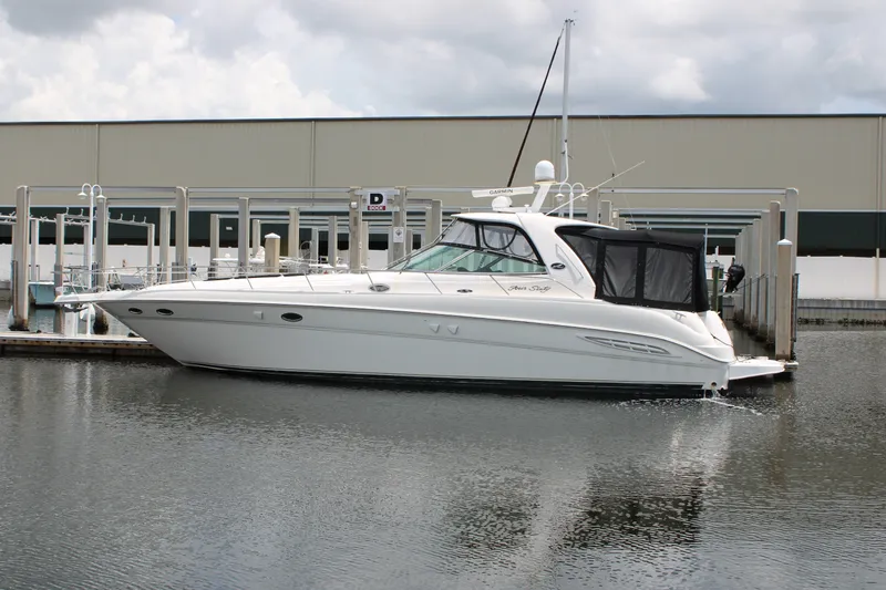 The Image of 2001 Sea Ray Sundancer 460 yacht docked at marina, featuring sleek white design. - 0
